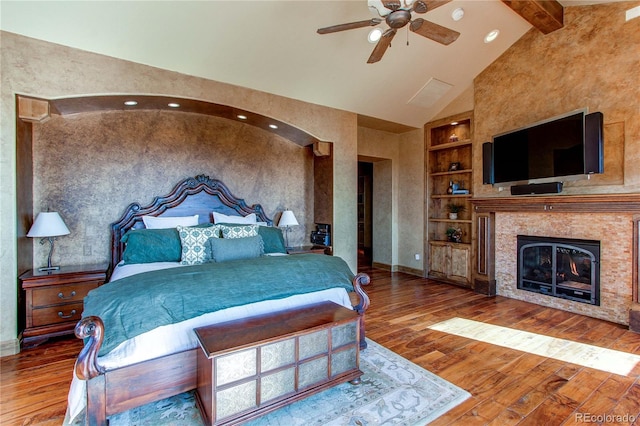 bedroom with wood-type flooring, beam ceiling, ceiling fan, and high vaulted ceiling