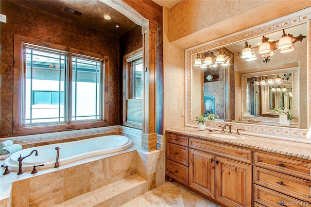 bathroom with a relaxing tiled tub and vanity