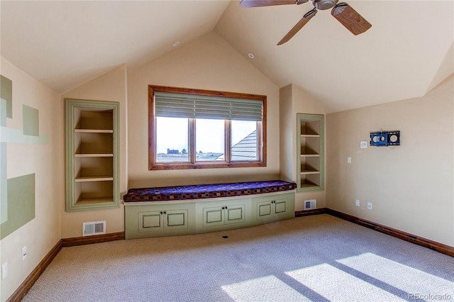 interior space with light carpet, vaulted ceiling, ceiling fan, and built in features