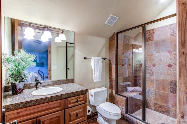 bathroom featuring a shower with shower door, vanity, a textured ceiling, lofted ceiling, and toilet