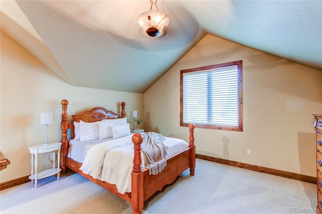 carpeted bedroom featuring lofted ceiling