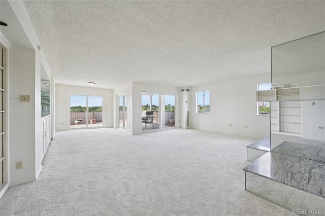 carpeted living room featuring a textured ceiling