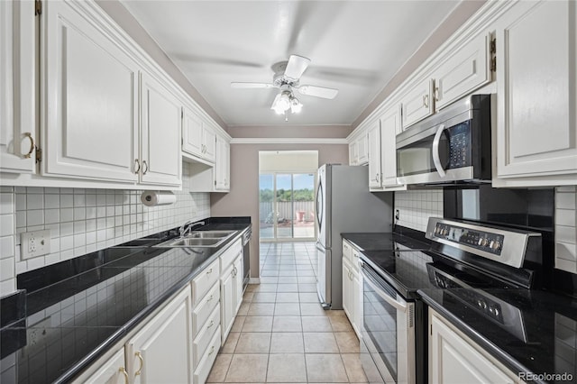 kitchen featuring white cabinets, light tile patterned floors, sink, and appliances with stainless steel finishes