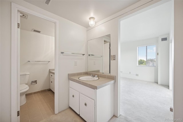 bathroom featuring vanity and toilet