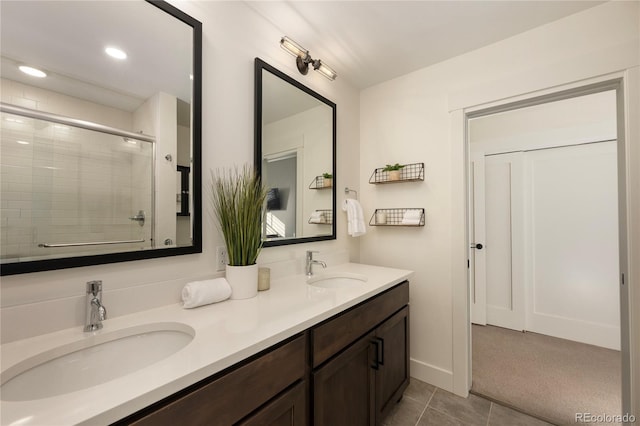 bathroom with tile patterned flooring, vanity, and a shower with shower door