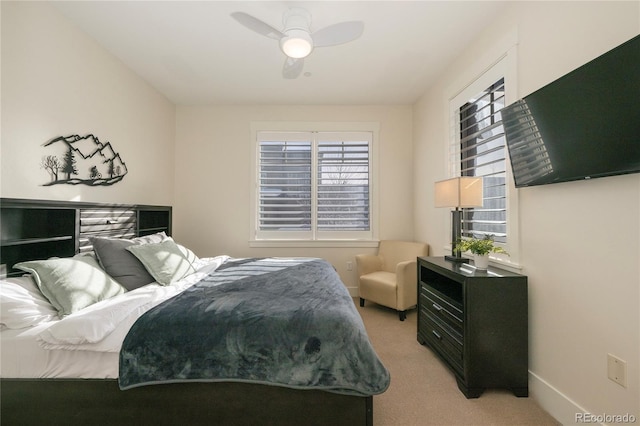 bedroom with ceiling fan and light carpet