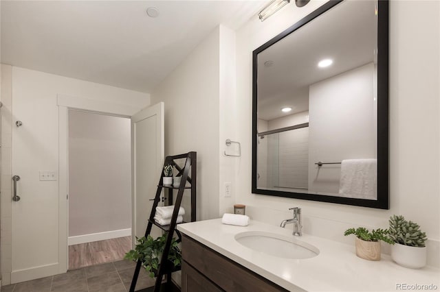 bathroom with tile patterned flooring, vanity, and a shower with shower door