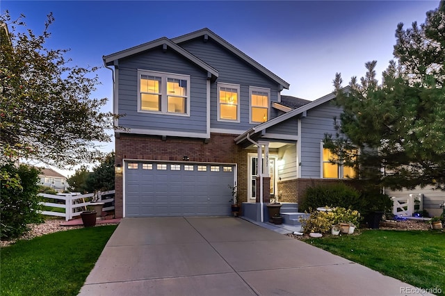 view of front of property with a garage and a yard