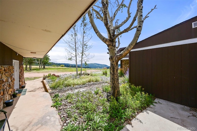 view of yard featuring a mountain view and a rural view