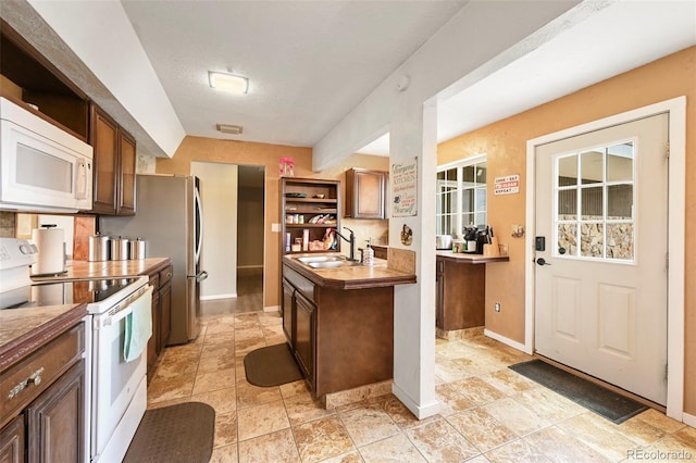 kitchen featuring white appliances and sink