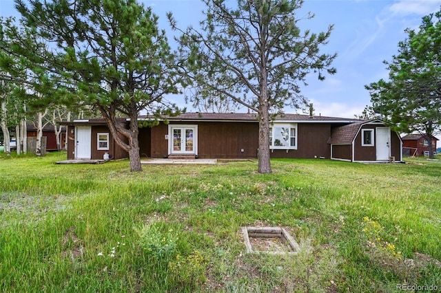 exterior space featuring a lawn and french doors