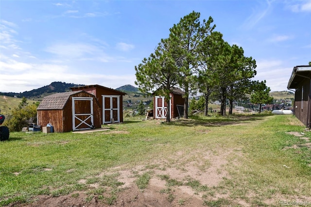 view of yard featuring a mountain view and a storage unit