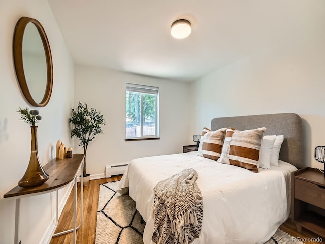 4418 W 11th Ave, Denver, CO 80204 - bedroom with a baseboard radiator and wood finished floors