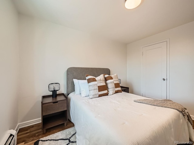 4418 W 11th Ave, Denver, CO 80204 - bedroom featuring a baseboard radiator and wood finished floors