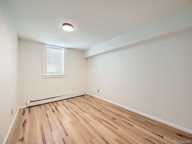 4418 W 11th Ave, Denver, CO 80204 - spare room featuring baseboard heating and wood finished floors