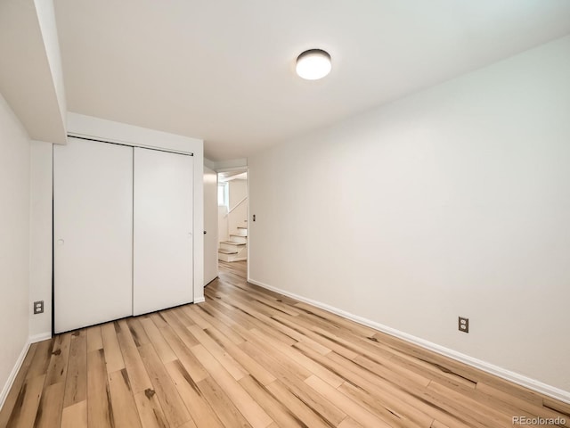 4418 W 11th Ave, Denver, CO 80204 - unfurnished bedroom with light wood-style floors and a closet