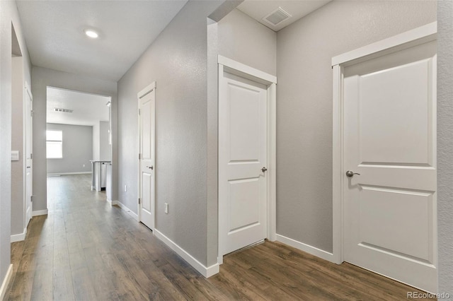 14259 Beebalm Ave, Parker, CO 80134 - corridor with dark wood-type flooring and baseboards