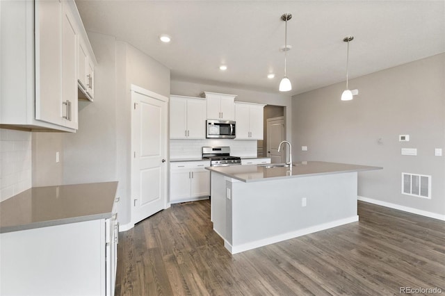 14259 Beebalm Ave, Parker, CO 80134 - kitchen with stainless steel appliances, dark wood-style flooring, backsplash, baseboards, and white cabinets
