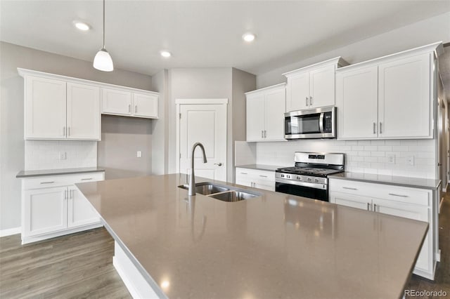14259 Beebalm Ave, Parker, CO 80134 - kitchen with appliances with stainless steel finishes, a sink, a kitchen island with sink, white cabinetry, and recessed lighting