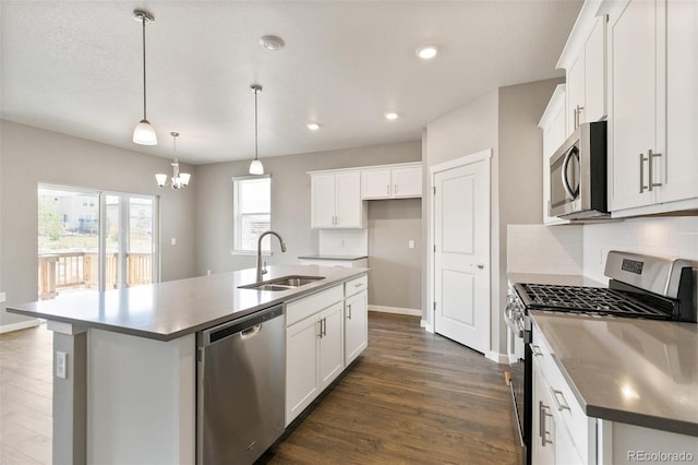 14259 Beebalm Ave, Parker, CO 80134 - kitchen featuring appliances with stainless steel finishes, a sink, decorative backsplash, a center island with sink, and a chandelier