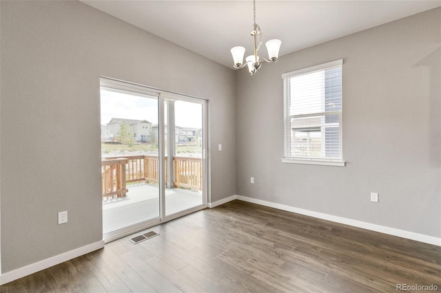 14259 Beebalm Ave, Parker, CO 80134 - unfurnished room featuring a chandelier, wood finished floors, and baseboards