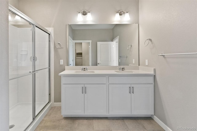 14259 Beebalm Ave, Parker, CO 80134 - full bath featuring a stall shower, double vanity, baseboards, and a spacious closet