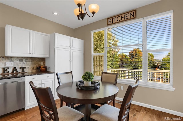 dining room with an inviting chandelier and light hardwood / wood-style flooring