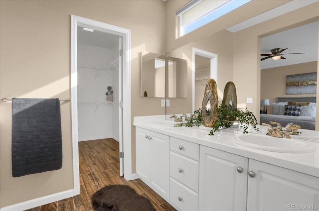 bathroom with wood-type flooring, vanity, and ceiling fan