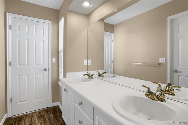 bathroom with hardwood / wood-style flooring and vanity