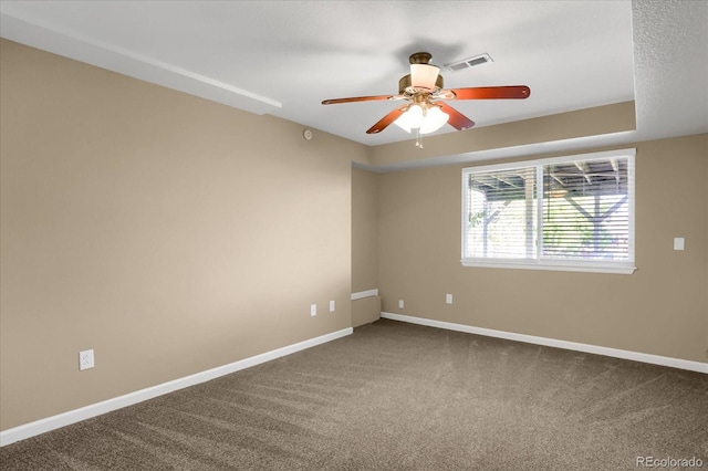 carpeted spare room with ceiling fan