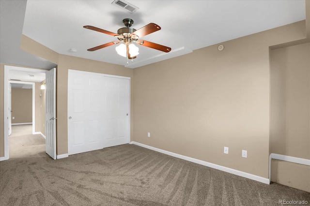 unfurnished bedroom featuring a closet, carpet flooring, and ceiling fan