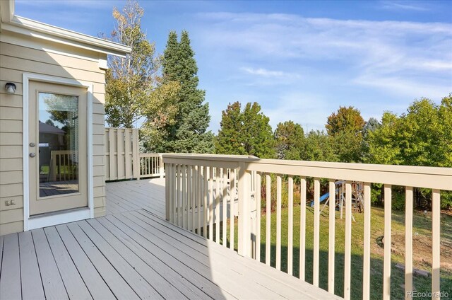 wooden terrace with a yard