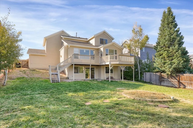 back of house featuring a deck and a yard