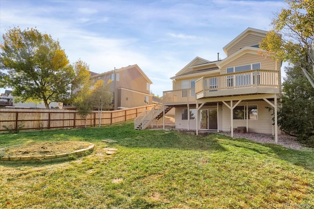 back of house featuring a deck and a lawn