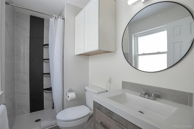 bathroom featuring a shower with curtain, vanity, and toilet