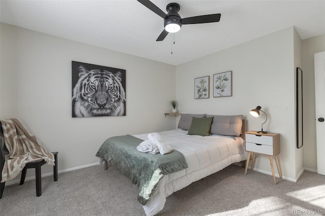 bedroom with a textured ceiling, carpet floors, and ceiling fan