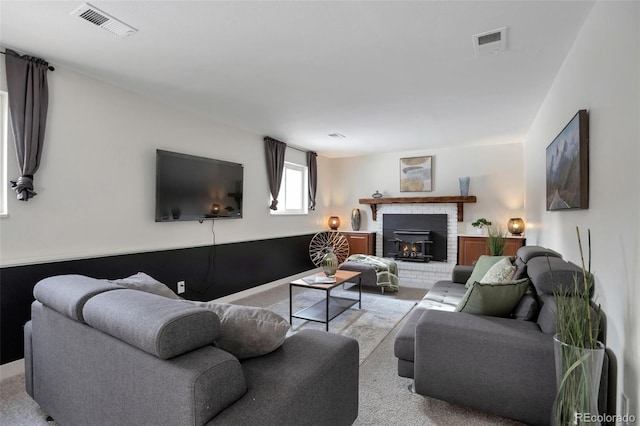 living room featuring light carpet and a fireplace