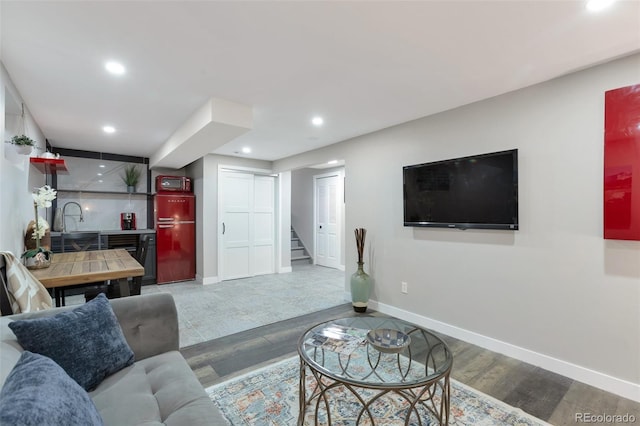 living room featuring sink and hardwood / wood-style flooring