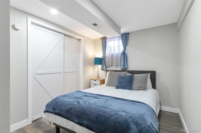 bedroom with hardwood / wood-style flooring and a closet