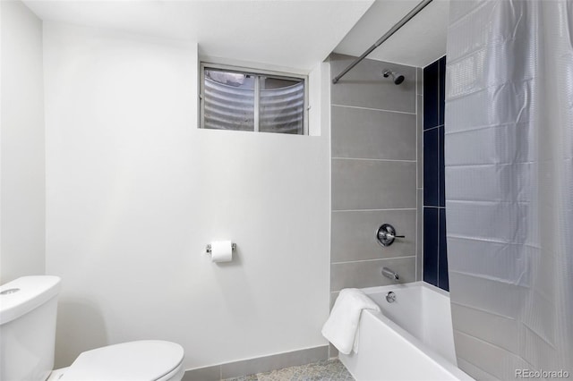 bathroom featuring shower / bath combo and toilet