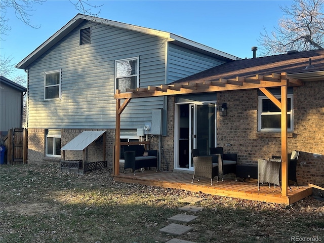 rear view of house featuring a wooden deck