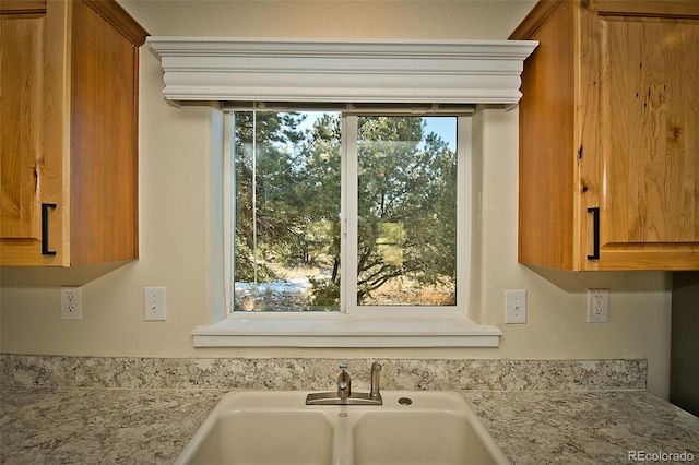 interior details with light stone counters and sink