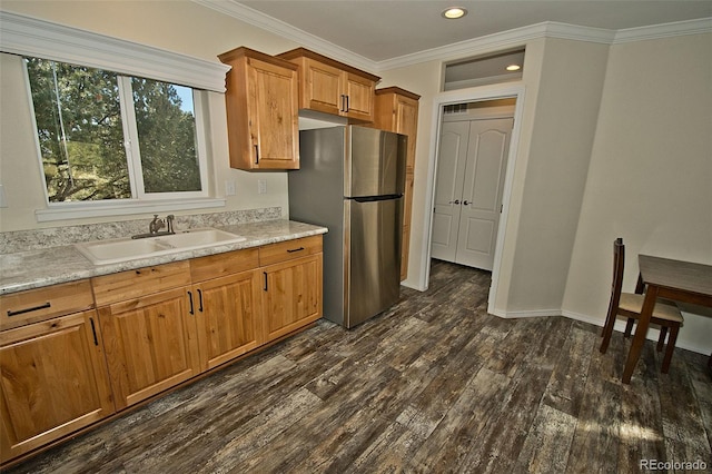 kitchen featuring stainless steel fridge, dark wood-type flooring, light stone countertops, ornamental molding, and sink