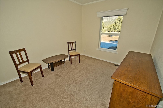 sitting room featuring ornamental molding and light carpet