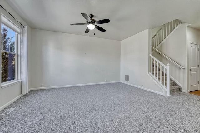 spare room featuring carpet flooring and ceiling fan