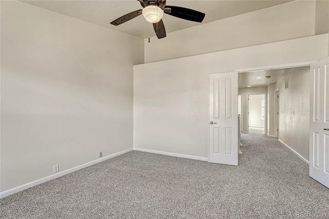 spare room featuring ceiling fan and carpet floors