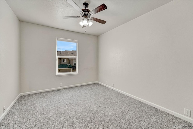 carpeted spare room with ceiling fan