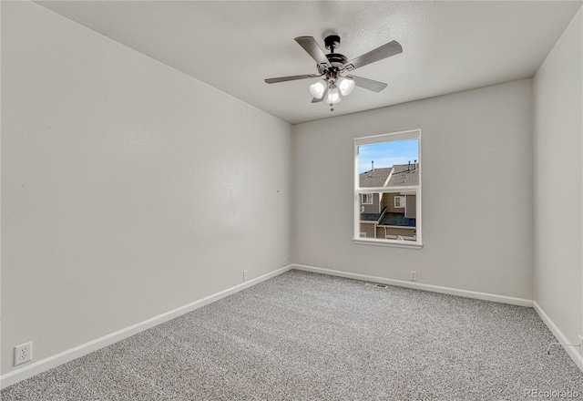 carpeted spare room with ceiling fan