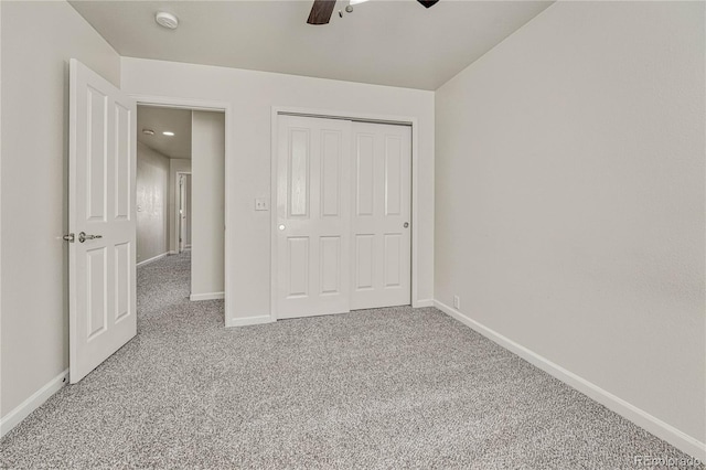 unfurnished bedroom featuring carpet flooring, ceiling fan, and a closet