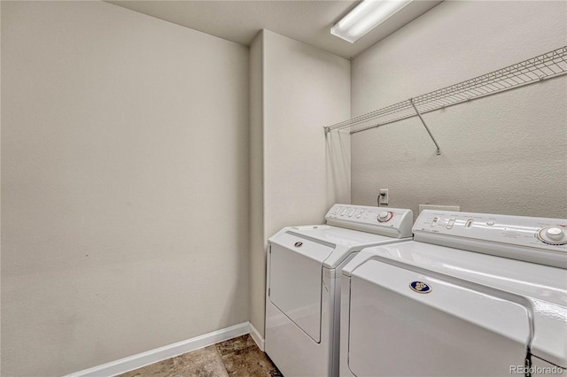 laundry room with washing machine and clothes dryer